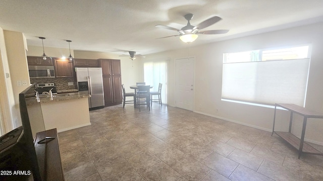 14620 N Yerba Buena Way Unit B, Fountain Hills, AZ 85268 - kitchen with appliances with stainless steel finishes, tasteful backsplash, a ceiling fan, hanging light fixtures, and baseboards