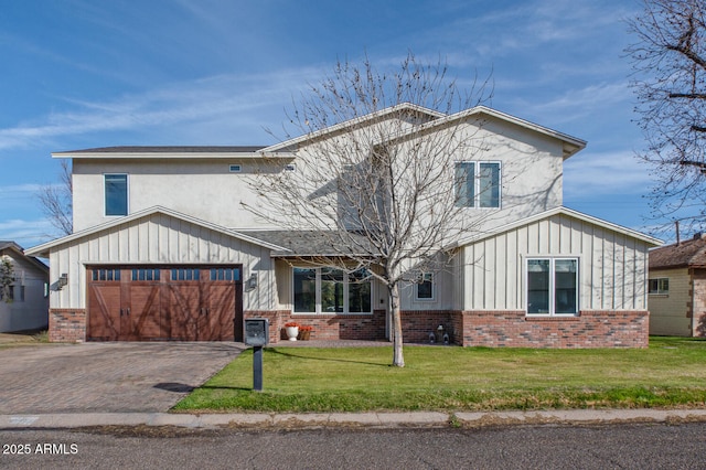 4306 E Flower St, Phoenix, AZ 85018 - view of front of home featuring board and batten siding, brick siding, a front yard, and decorative driveway