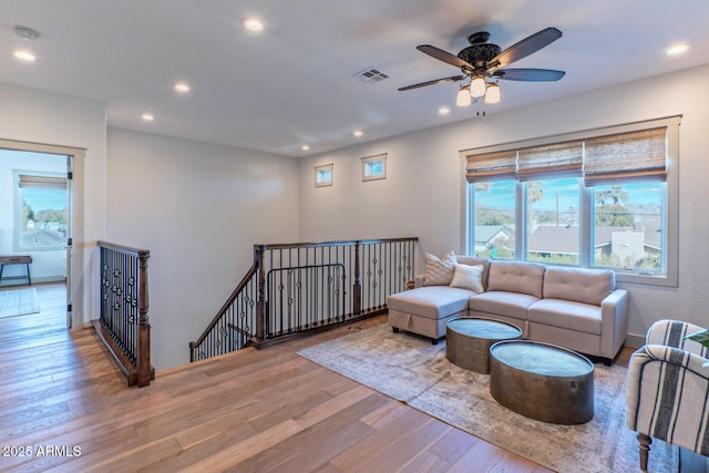 living room featuring ceiling fan and light hardwood / wood-style flooring