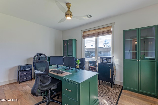 home office with ceiling fan and light hardwood / wood-style flooring