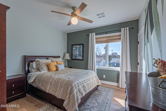 bedroom with ceiling fan and light hardwood / wood-style floors