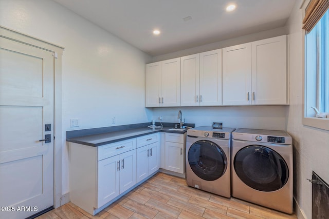 laundry area featuring cabinets, sink, and washing machine and dryer