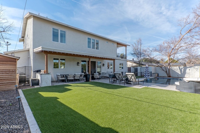 back of property featuring a fenced in pool, a yard, central air condition unit, and a patio area