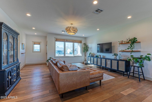 living room featuring a notable chandelier and wood-type flooring