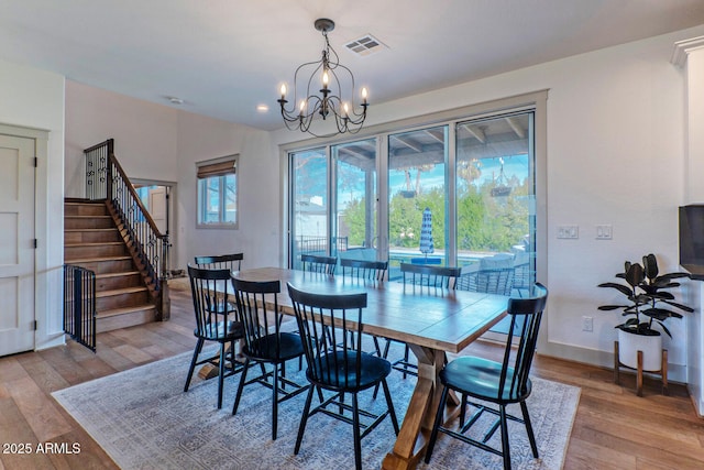 dining space with an inviting chandelier and light wood-type flooring