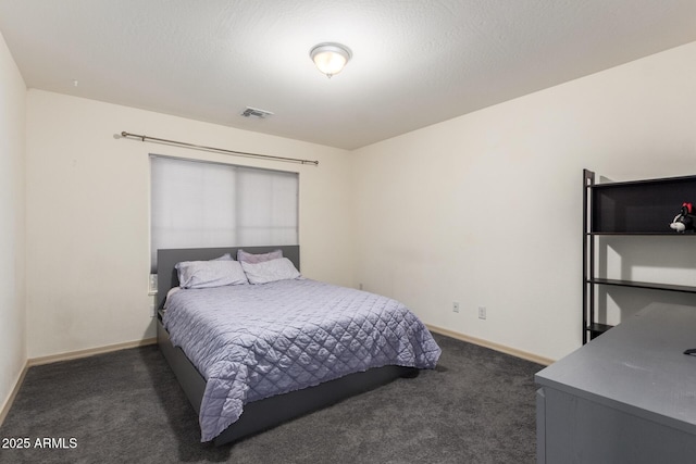 carpeted bedroom featuring a textured ceiling