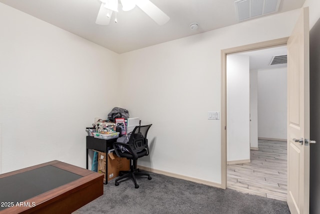 office area featuring light carpet and ceiling fan