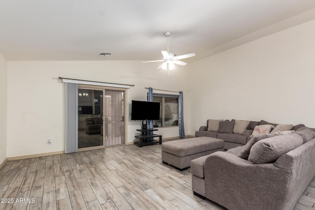 living room with vaulted ceiling, ceiling fan, and light wood-type flooring