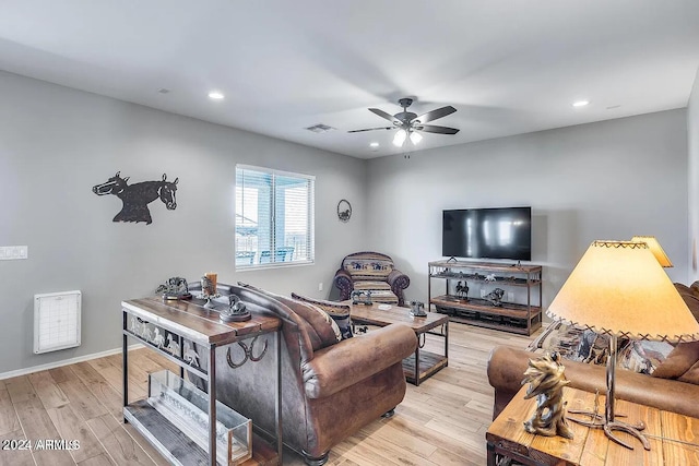 living room with light hardwood / wood-style flooring and ceiling fan