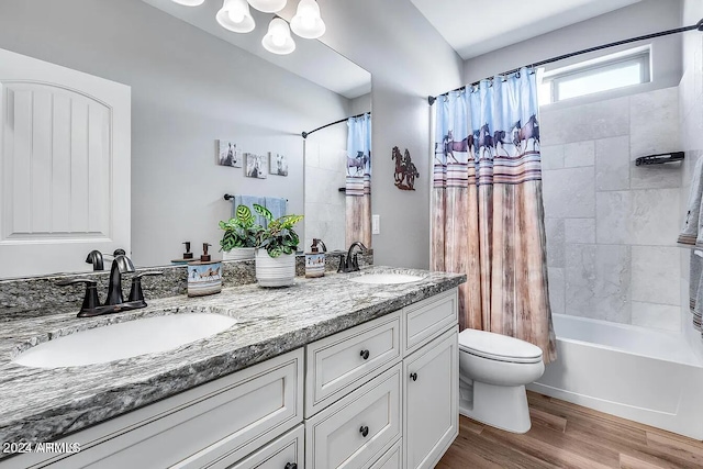 full bathroom featuring shower / tub combo, vanity, hardwood / wood-style flooring, and toilet