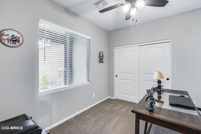 carpeted office space featuring ceiling fan