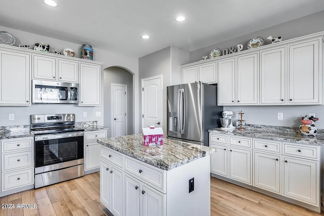 kitchen featuring a center island, white cabinets, and stainless steel appliances