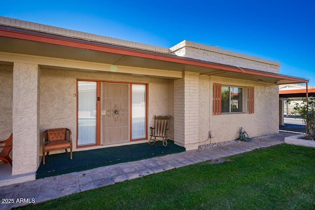 view of exterior entry with stucco siding