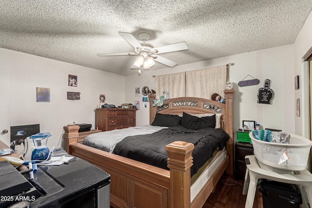 bedroom with dark wood-style floors, ceiling fan, and a textured ceiling