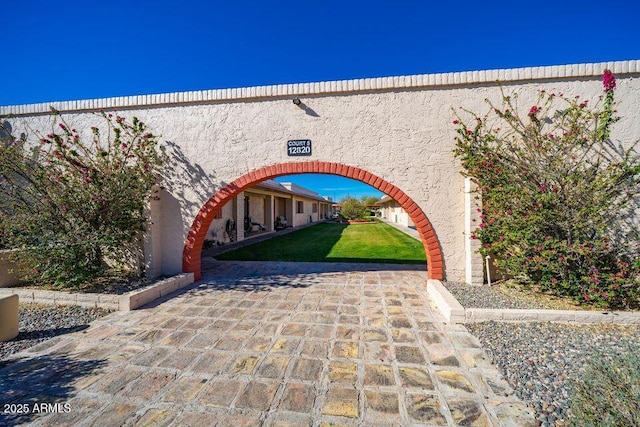 view of gate featuring a yard