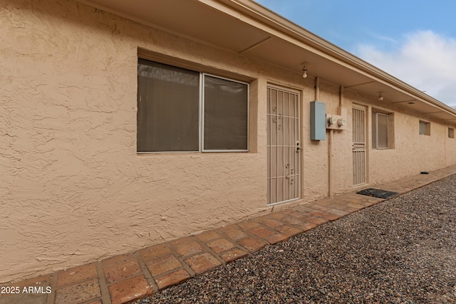 property entrance featuring stucco siding