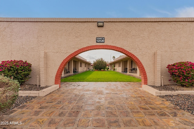 exterior space featuring a yard and stucco siding