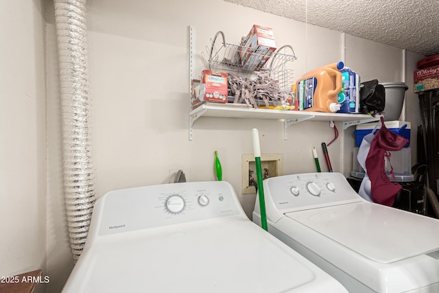 laundry area featuring a textured ceiling, laundry area, and independent washer and dryer