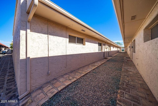 view of side of property with stucco siding