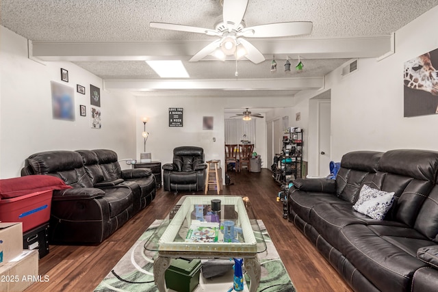 living room featuring beam ceiling, visible vents, ceiling fan, a textured ceiling, and wood finished floors