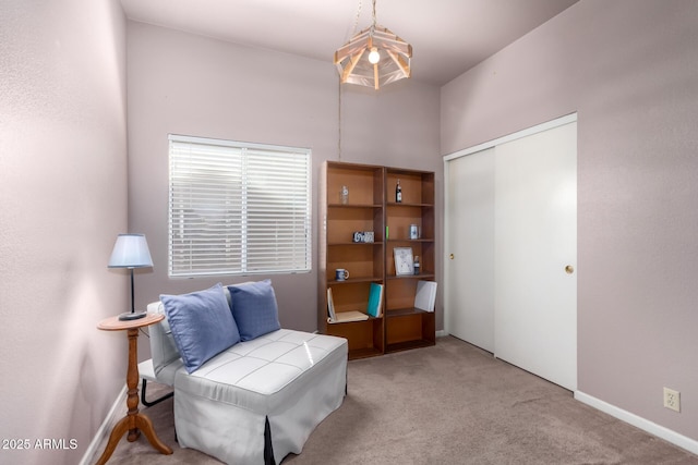 living area featuring carpet floors and baseboards