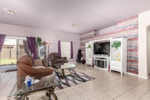 living area with visible vents and light tile patterned flooring