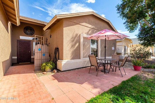 view of patio / terrace featuring a gate, fence, and outdoor dining area