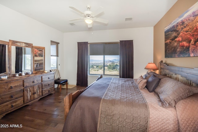 bedroom with dark hardwood / wood-style floors and ceiling fan