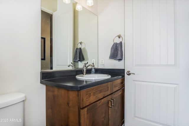 bathroom featuring vanity and toilet