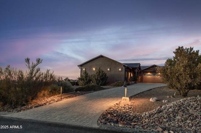 property exterior at dusk with a garage