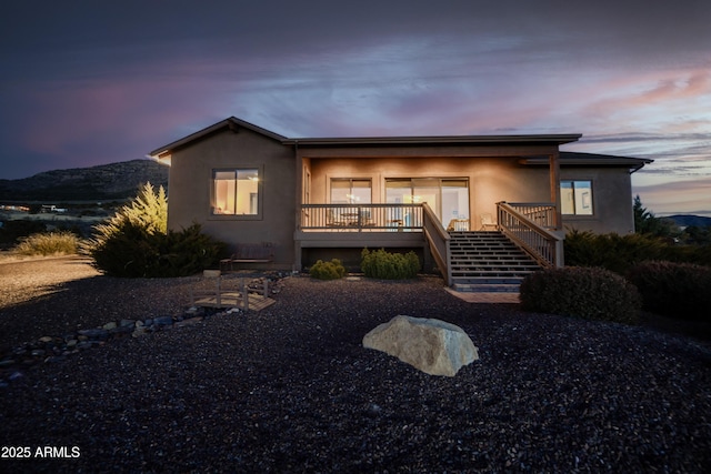 view of front facade with a deck with mountain view