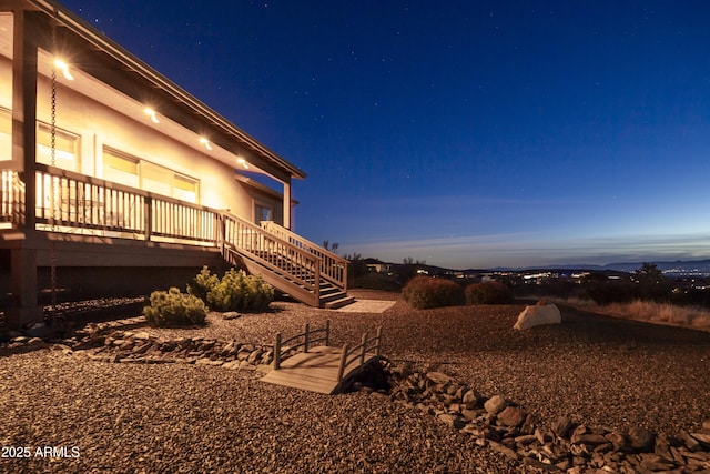 yard at dusk with a wooden deck