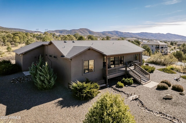 view of front facade with a deck with mountain view