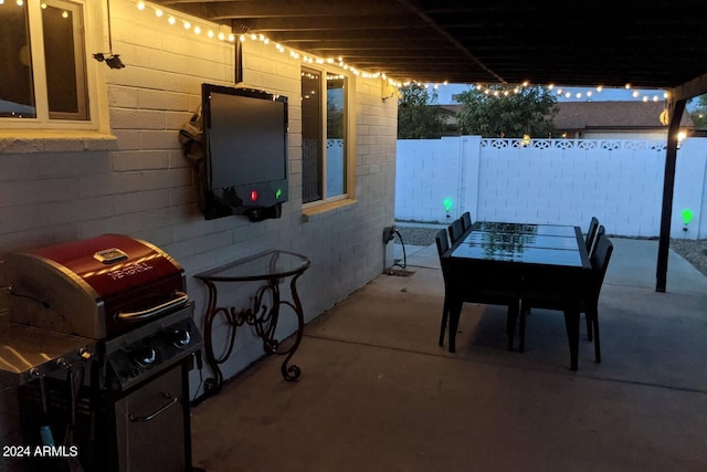 view of patio / terrace with fence and a grill