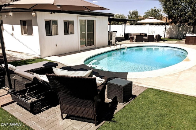 view of swimming pool with a fenced in pool, a patio area, fence, and an outdoor hangout area