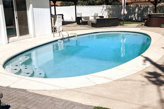 view of pool featuring a patio, fence, an outdoor living space, and a hot tub