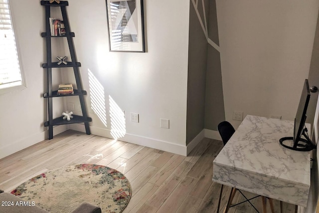 dining space with wood finished floors and baseboards