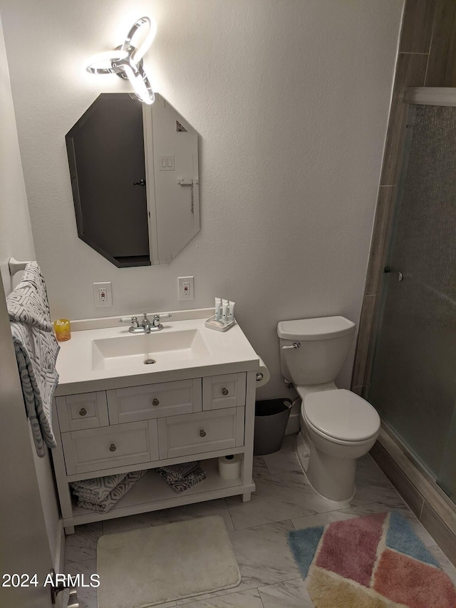 full bathroom with a stall shower, marble finish floor, vanity, and toilet