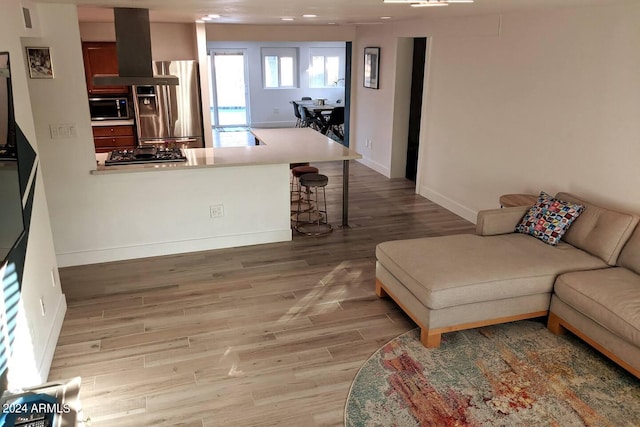 living area featuring light wood-style flooring and baseboards