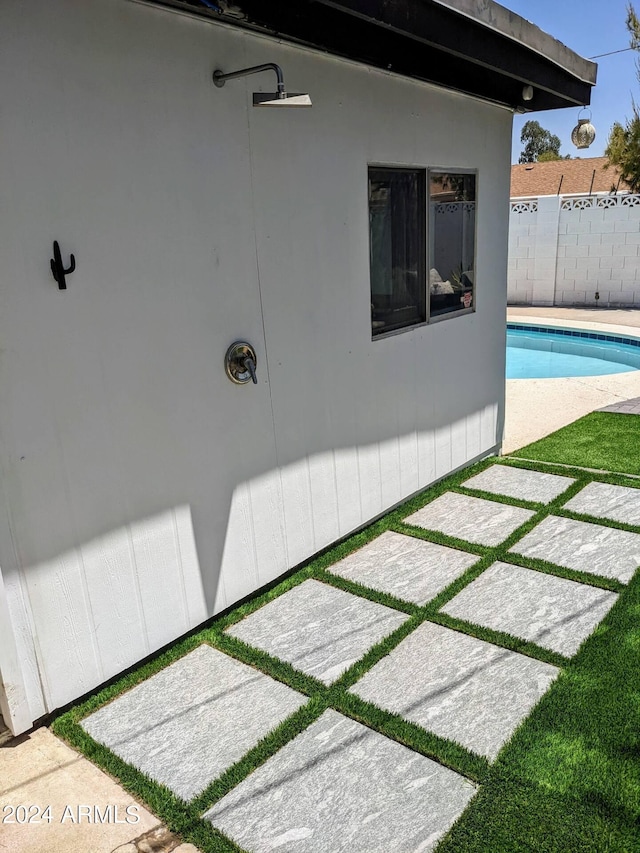 exterior space featuring fence and a fenced in pool