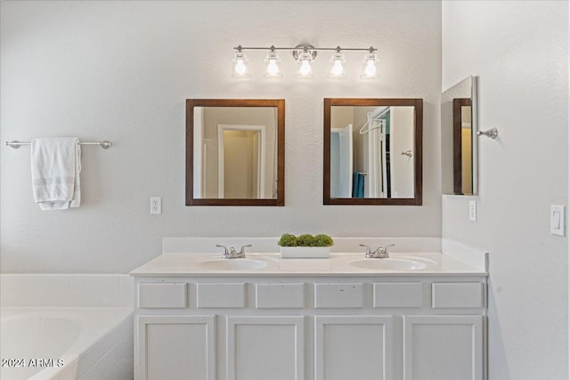 bathroom with vanity and tiled tub