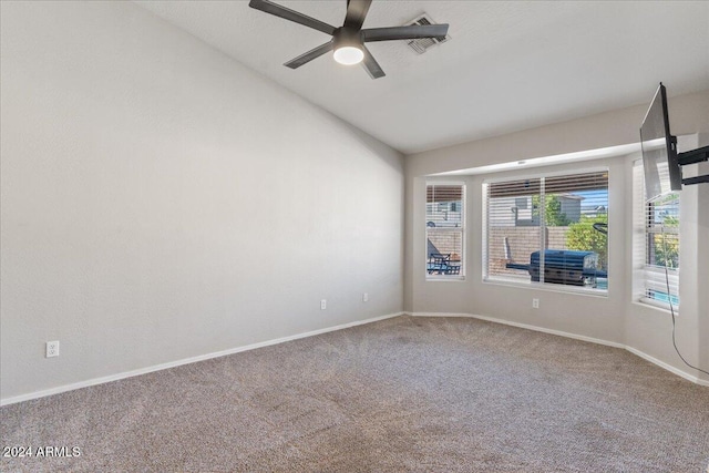 spare room with ceiling fan, carpet flooring, and vaulted ceiling