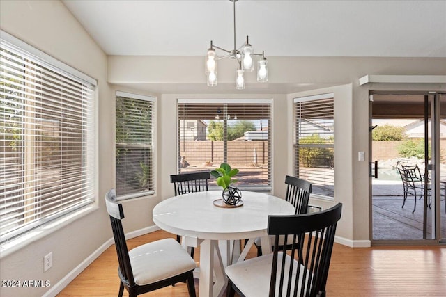 dining room featuring an inviting chandelier and light wood-type flooring