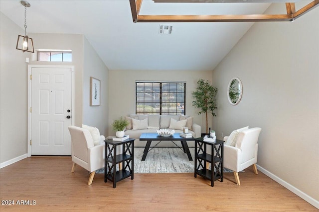 interior space featuring vaulted ceiling, light wood-type flooring, and plenty of natural light