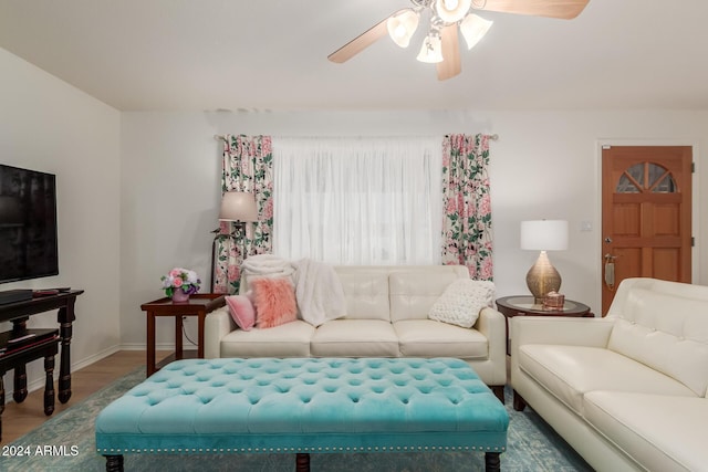 living room featuring ceiling fan and wood-type flooring