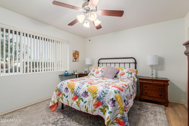 bedroom with ceiling fan and hardwood / wood-style floors