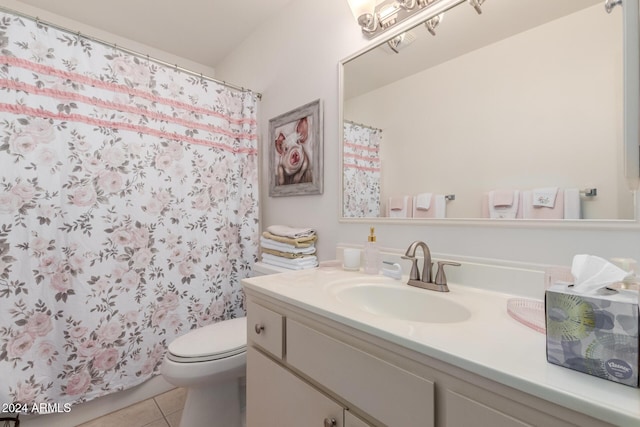 bathroom with tile patterned flooring, vanity, and toilet