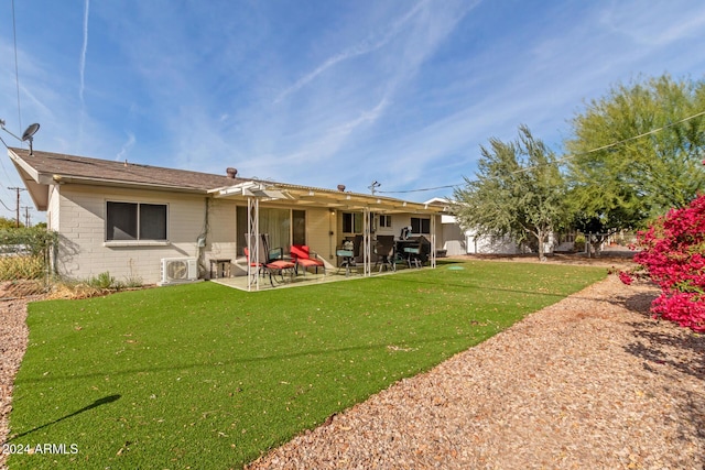 back of house featuring a yard and a patio area