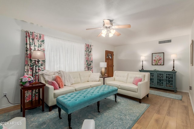 living room with ceiling fan and light wood-type flooring