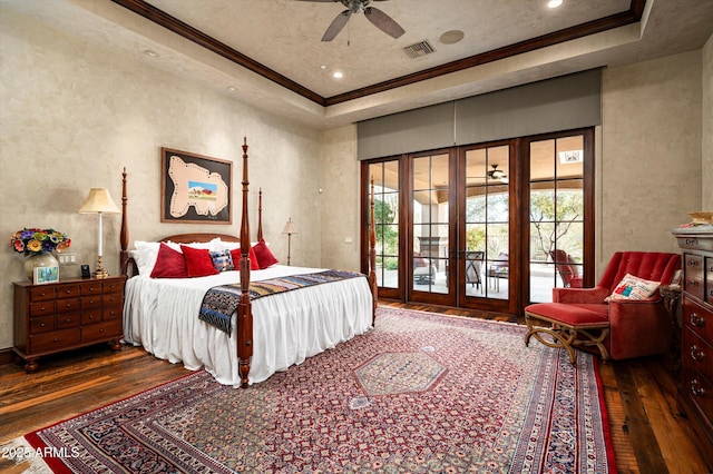 bedroom with french doors, hardwood / wood-style flooring, a tray ceiling, access to exterior, and ornamental molding